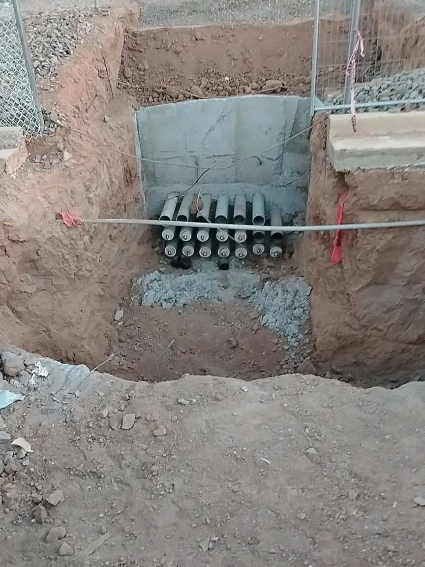 Utility vault with a bank of conduit coming in, before backfill
